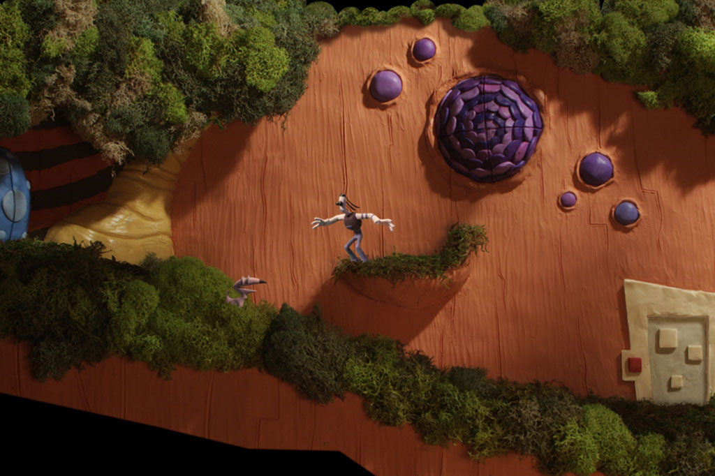 Tommynaut and Beak-Beak crossing a mossy Armikrog route