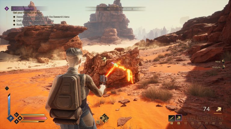 A player mining a glowing ore node in Dune Awakening