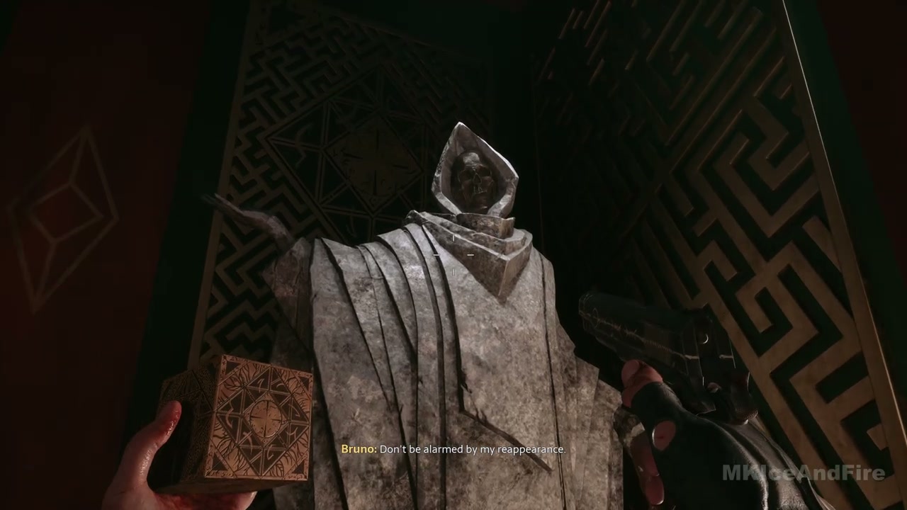 The hooded staff statue with its staff held upright
