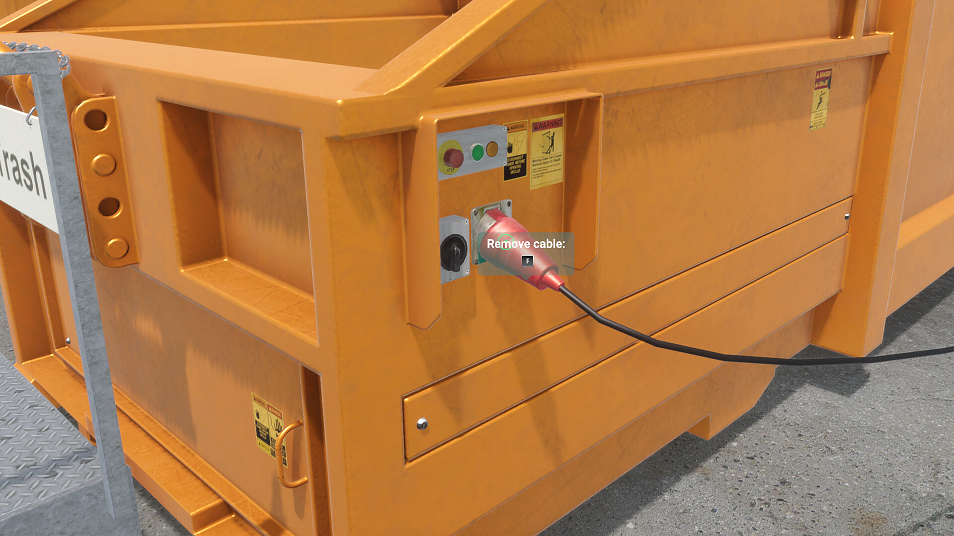 Red power cable connected to the socket below a recycling compactor's control buttons